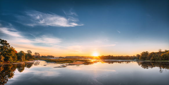 Panorama Of Autumn River Landscape In Europe At Sunrise. Sun Shine Over Blue Water Lake Or River At Sunset. Nature At Sunny Morning. Woods On Riverside Coast.