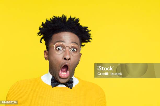Portrait Of Shocked Nerdy Young Man Staring At Camera Stock Photo - Download Image Now