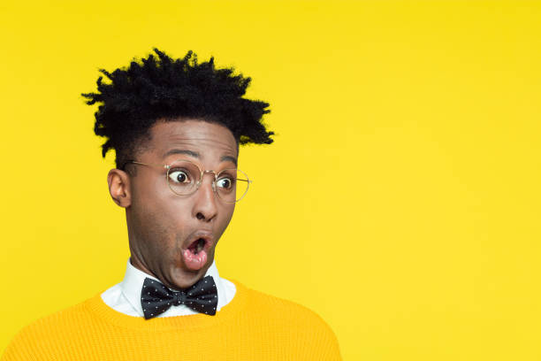 istock Portrait of surprised geeky young man rolling eyes 996828708