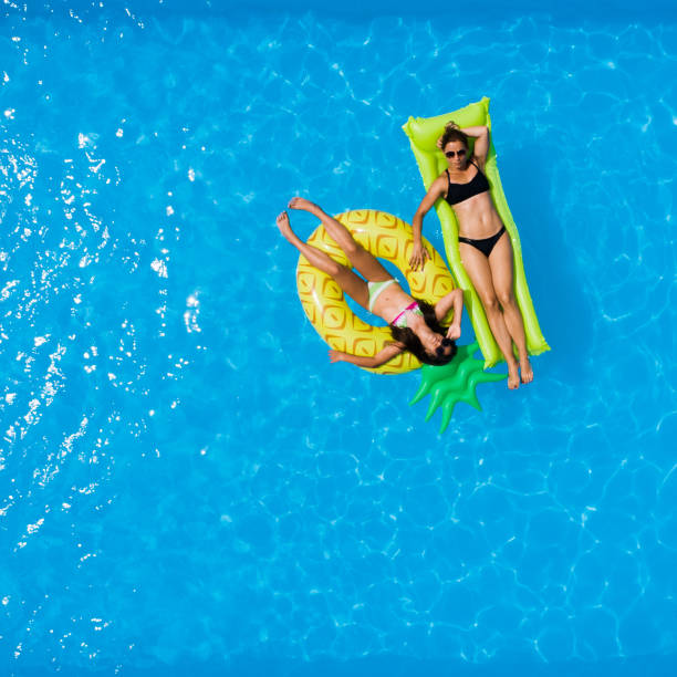 istock Mother and daughter in the pool 996829010