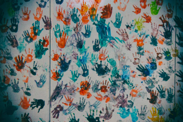 istock Wall painted by colourful children handprint 996832836