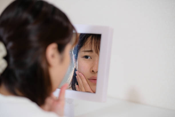 woman taking care of rough skin face care of rough skin, dry skin and skin problem complexion stock pictures, royalty-free photos & images