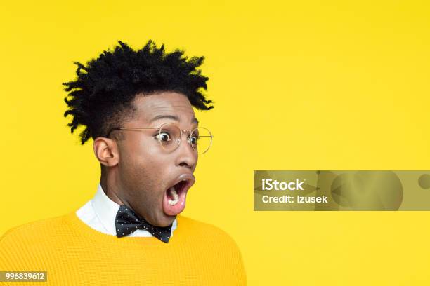 Portrait Of Surprised Geeky Young Man Looking Away Stock Photo - Download Image Now - Surprise, Awe, Humor