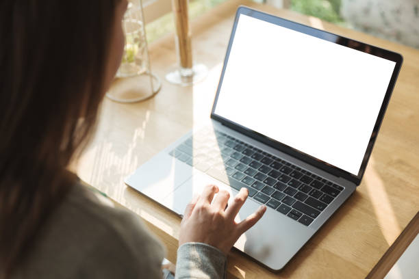 istock Women using laptop with blank screen at table in the office. 996842804