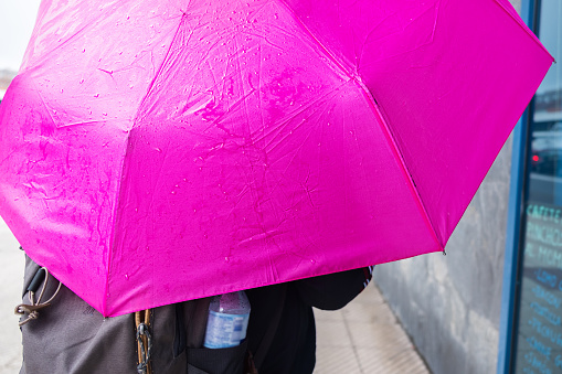 Tourist under an umbrella in the city