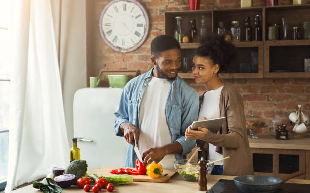 istock African-american couple searching for recipe using digital tablet 996843966