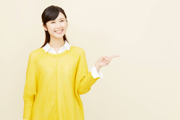 istock Asian woman pointing side 996846472