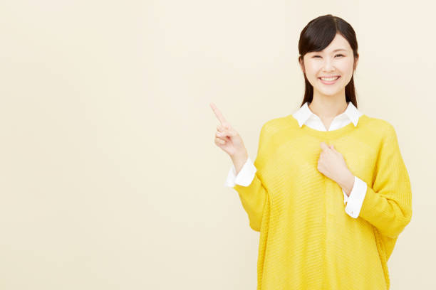istock Asian woman pointing side 996846476