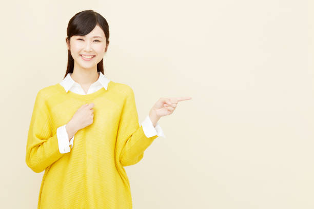istock Asian woman pointing side 996846480