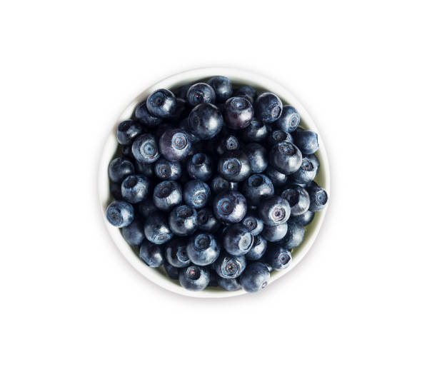 istock Top view. Bilberres in a bowl isolated on white. Ripe blaeberries with copy space for text. Blueberries basil on a white background. 996850442