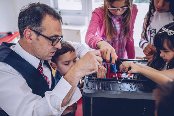 istock Kids repairing computer in school 996850898