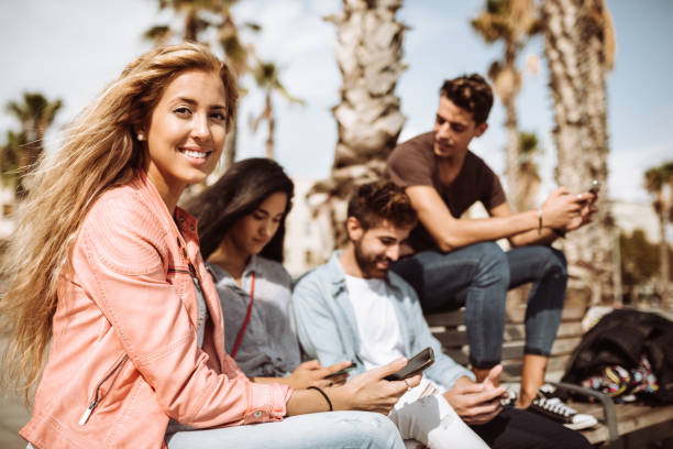istock group of friends using social media all together 996857910
