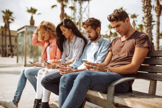 istock group of friends using social media all together 996860320