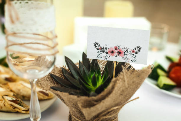 istock gift plant and a glass on a wedding table 996860614