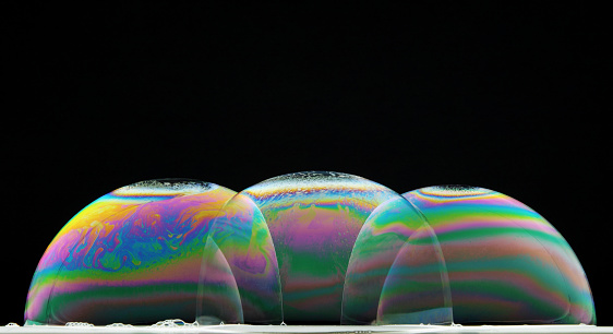 the colors generated by the interference of light in soap bubbles