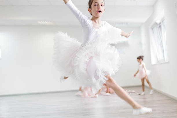 Child ballerina on ballet practice jumping