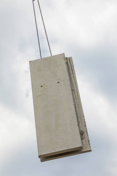 istock prefabricated wall is placed at the construction site with help of a huge crane 996880954
