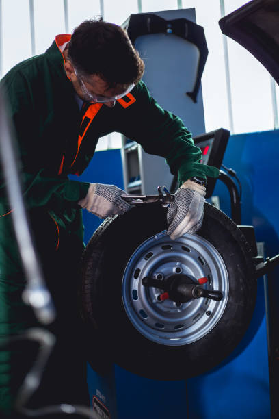 istock Mechanic removes car tire Machine for removing rubber from 996883060
