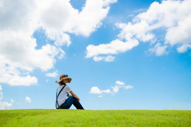 istock Woman relaxing in a meadow 996886828
