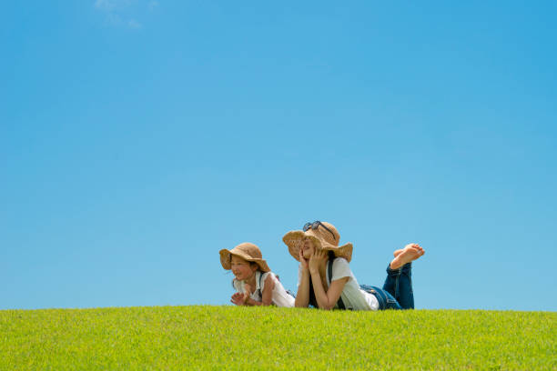 istock Mother and daughter relaxing in the meadow 996886864