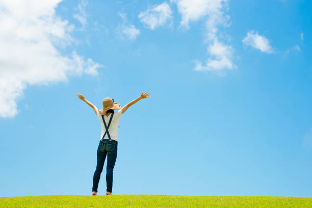 istock Woman relaxing in a meadow 996886954