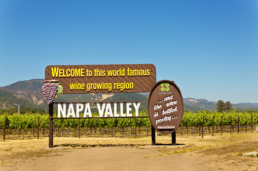 The road sign entrance of the vineyard and winery in Napa valley, California. Welcoming tourists and visitors to the famous wine country, the winemaking industry and agri-business in California.