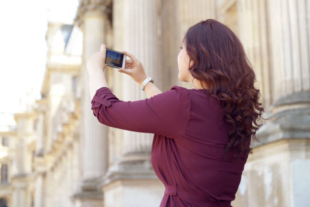 istock young woman walks in Paris (with smartphone) 996893594