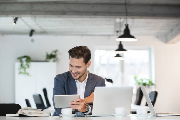 istock Happy young businessman working in office 996893962