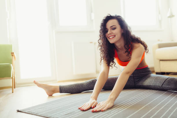 istock Young attractive sportswoman doing exercises at home 996895408