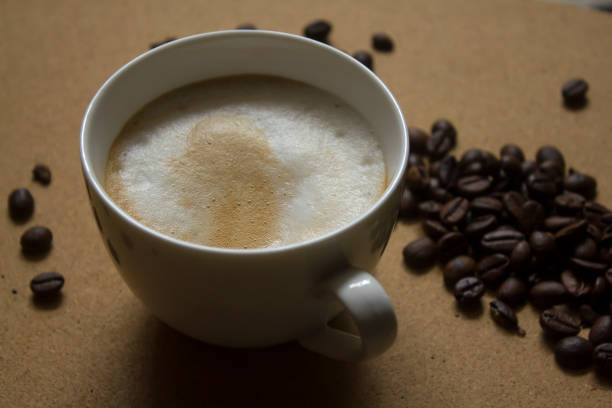 istock Milk froth in coffee mugs and coffee beans 996898908