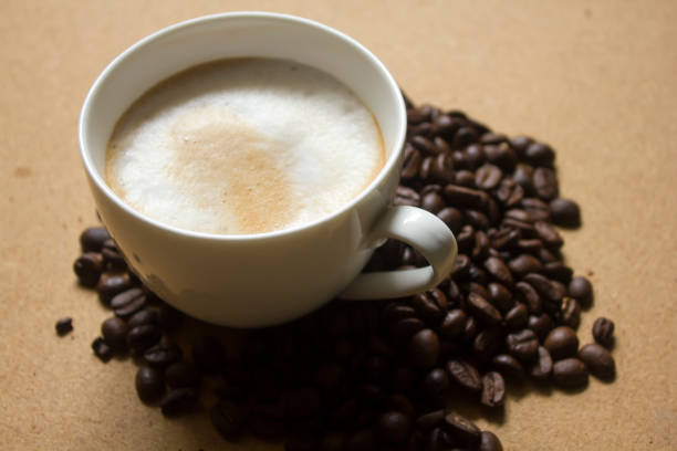 istock Milk froth in coffee mugs and coffee beans 996898966
