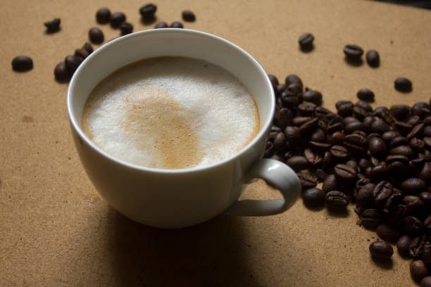 istock Milk froth in coffee mugs and coffee beans 996898978