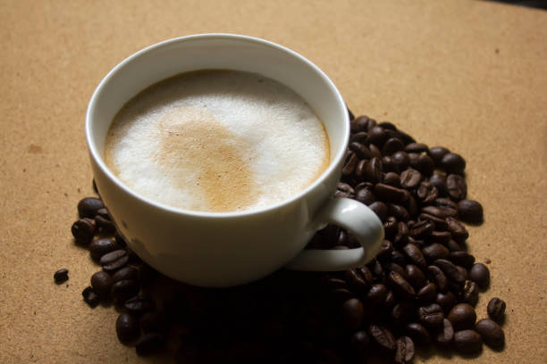 istock Milk froth in coffee mugs and coffee beans 996899008