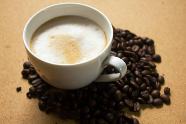 istock Milk froth in coffee mugs and coffee beans 996899094