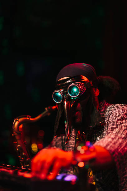 istock Man with mask playing music on stage 996899156