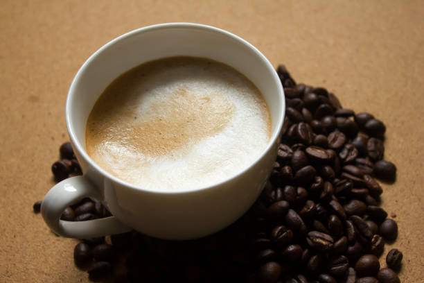 istock Milk froth in coffee mugs and coffee beans 996899182