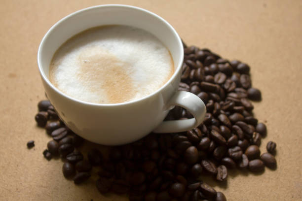 istock Milk froth in coffee mugs and coffee beans 996899464
