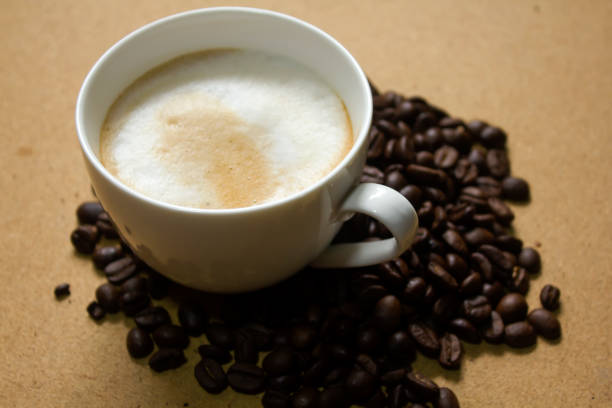 istock Milk froth in coffee mugs and coffee beans 996899690