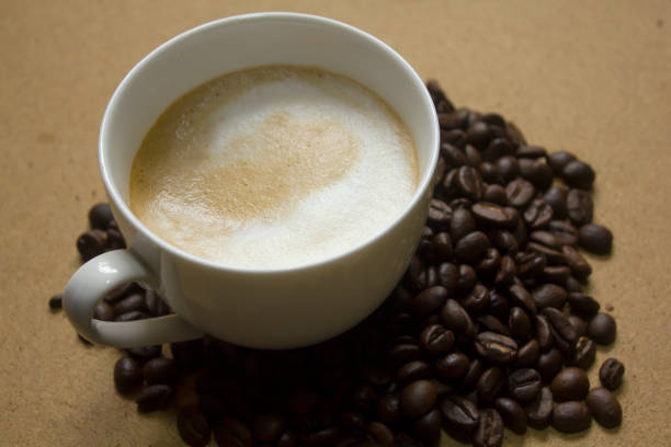 istock Milk froth in coffee mugs and coffee beans 996901822