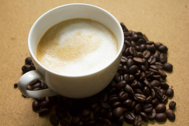 istock Milk froth in coffee mugs and coffee beans 996901860