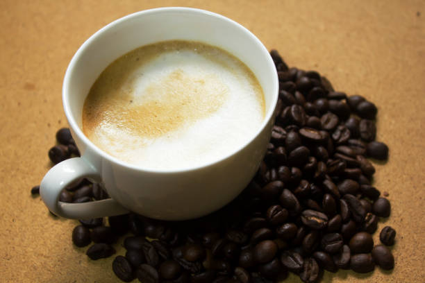 istock Milk froth in coffee mugs and coffee beans 996901964