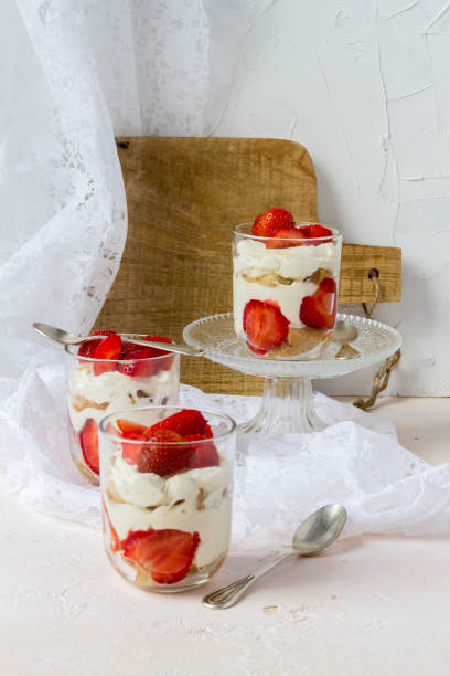 istock Strawberry tiramisu. Glasses. Silver spoons. Light background. 996902874