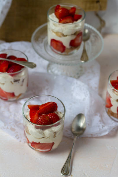 istock Strawberry tiramisu. Glasses. Silver spoons. Light background. 996908444