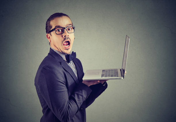 istock Shocked funny man reading news on laptop 996928626