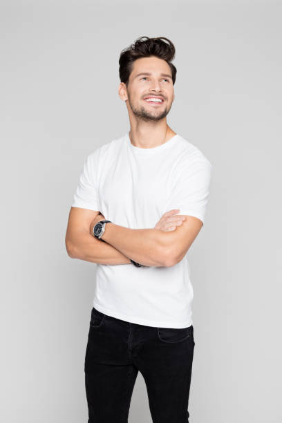 istock Smiling man standing with his arms crossed 996928912