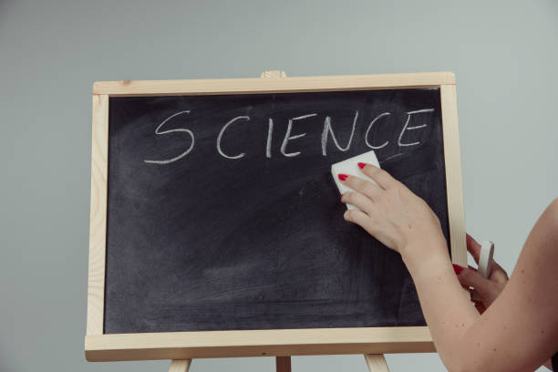 istock A teacher writing science, drawing chemistry elements on dark chalkboard by hand 996939382