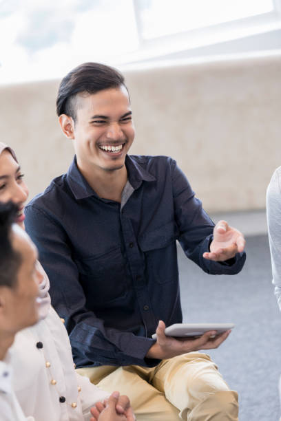 istock Cheerful man during business seminar 996939642