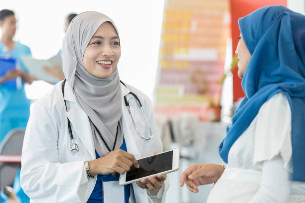 istock Cheerful doctor meets with patient 996939728