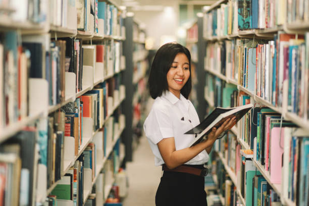istock Young Asian student is searching for books in the library 996953764