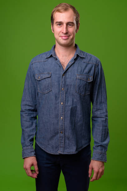 istock Young man against green background 996957276